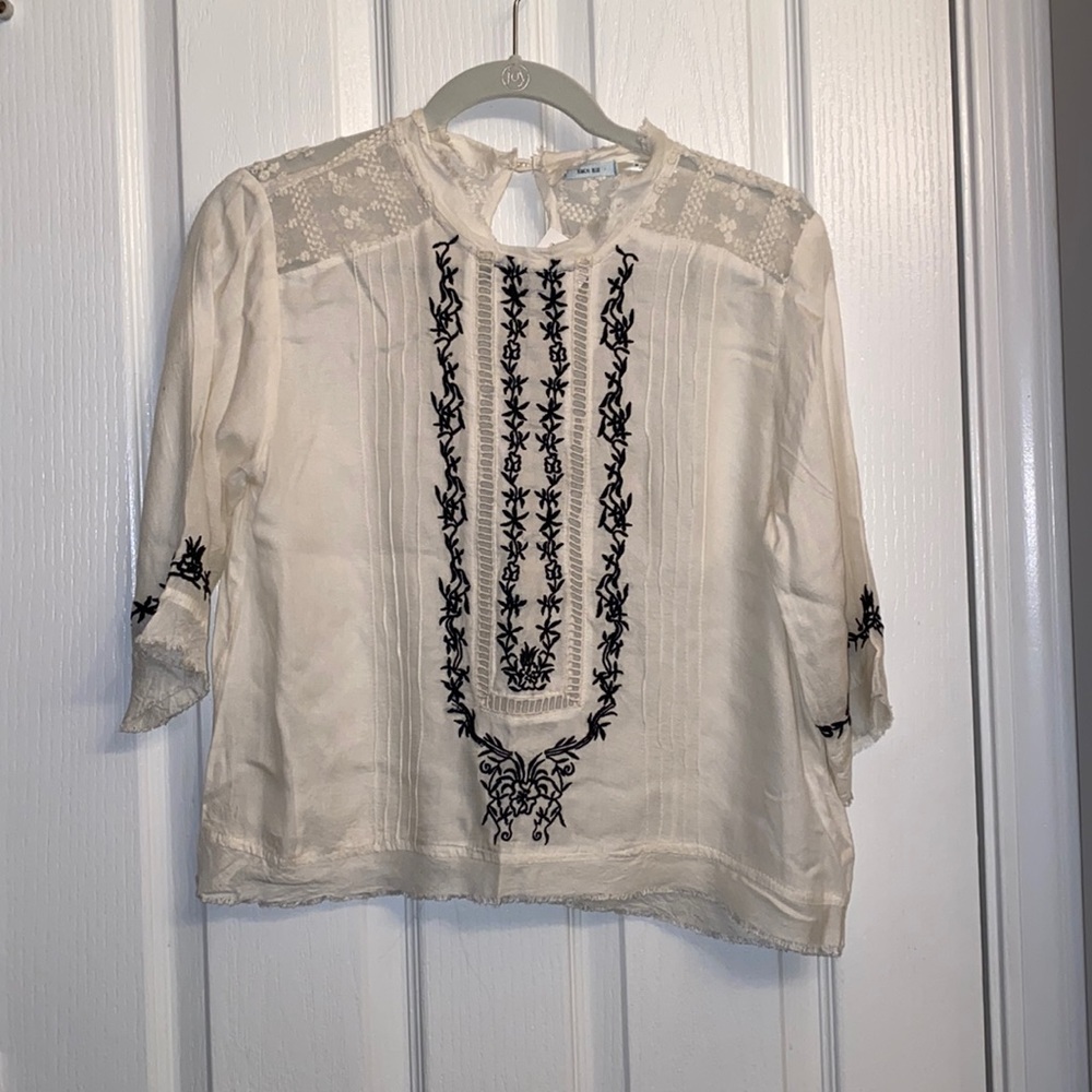 NWT. Free People Kimchi Blue Top. Lace detail on shoulders. BRAND NEW WITH TAGS.